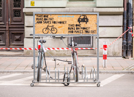 Krakow, Poland, Dr. Albin bicycle shop and service eco bike ad campaign. Ecology, money saving on cycling abstract concept, nobody, bike stand closeup, frontのeditorial素材