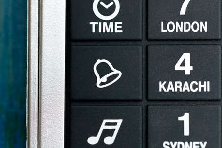 Alarm bell button icon, symbol macro, extreme closeup, object nobody. Pocket electronic organizer switch up close. Waking up, setting reminders, organizing and reminding abstract concept, nobodyの写真素材