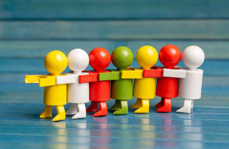 Group of people together, in a row, different colored figurines, business team strategy and teamwork abstract symbol, having each others back, togetherness concept, closeup, objects in the row, nobodyの写真素材