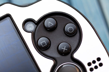 PS Vita, Playstation pocket video game console action buttons macro, closeup. Triangle, circle, cross, square controls detail. Handheld gaming consoles conceptのeditorial素材