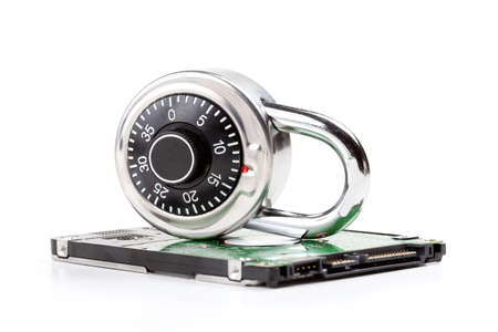 Locked HDD, hard drive password private data storage encryption abstract concept, nobody. Hard disk and a coded padlock isolated on white, cut out. Digital data safety measures, information securityの写真素材
