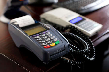 Point of sale, POS terminal device on the table in a store office, business, shop, retail area desk, object closeup, shallow dof, nobody. Contactless transactions, card payment commerce simple conceptの写真素材