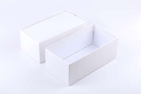 Simple blank white opened empty smartphone box premium quality paper mobile phone technology product container isolated on white background, cut out, open box template mockup, nobody. Unboxing conceptの写真素材