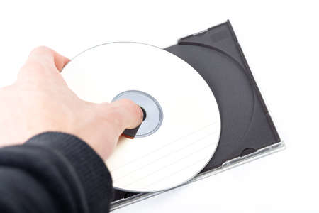 Anonymous man, hand taking out or putting in a simple blank empty CD or DVD disc in a CD-ROM box...