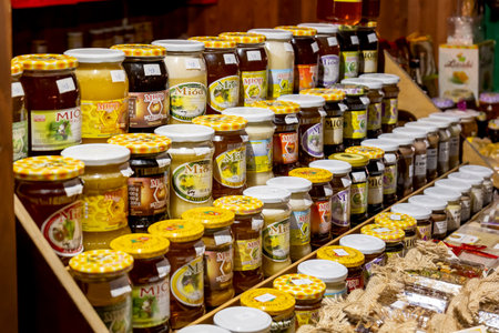Lots of different Polish branded honey glass jars, object group, shop, sweet traditional organic products variety, large selection, market stall, nobodyのeditorial素材