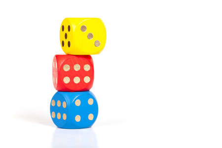 Three simple colorful game dice stacked on top of each other, unstable built structure, business...