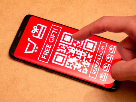 Man browsing through generic free gift promo cards, coupon mockup, shopping in an online store, coupons, vouchers, object closeup, e-commerce concept advertising, marketing, product promotion campaignの写真素材