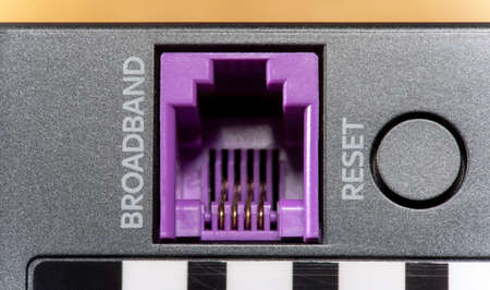 Broadband internet connection cable input socket, port on a network device modern router or WiFi access point, object detail, extreme closeup, zoom in. Networking, wide bandwidth data transmissionの写真素材