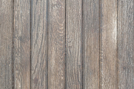 Simple used worn outdoors wooden table thin planks texture, wooden planks wall background surface structure up close, backdrop, nobody, no people. Light brown and gray natural wood backgroundの写真素材