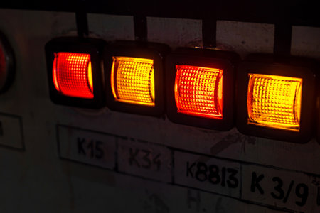 Simple abstract old retro industrial heavy duty equipment indicator lights illuminated controls, indicators in a dark room, old factory, power plant machines object macro detail, closeup, nobody.の写真素材
