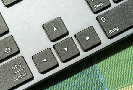 Arrow keys on a modern computer desktop PC keyboard, digital world navigation directional controls,...