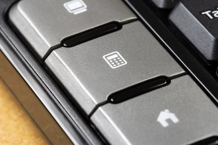 Close-up view showing the detail of a calculator shortcut key on a computer keyboard, doing...