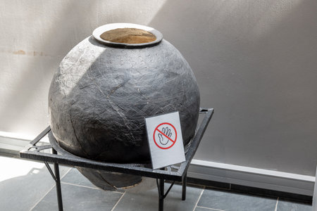 A large old ancient vase pot exhibit in a museum with a do not touch symbol sign in front. Valuable historic artifacts fragile easy to break priceless objects, fragility abstract concept, nobodyの写真素材