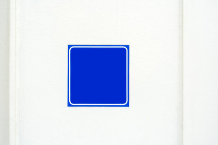 Simple minimal empty blank blue square information sign on a white wall, modern urban public space outdoor sign design with copy space, single symbol space, nobodyの写真素材