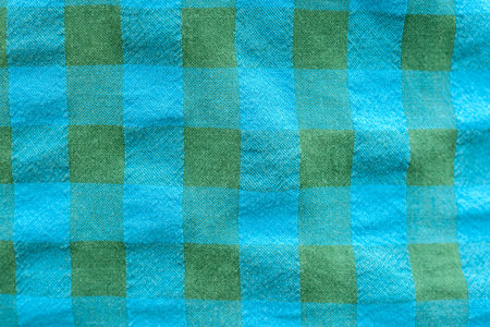 Blue and green checkered fabric textile closeup, cotton shirt material pattern with woven structure closeup textured cloth background macro detail for clothing design or manufacturing industry conceptの写真素材