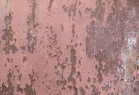 Rusty metal wall with peeling paint and corrosion, bright flaking surface grunge texture background,...