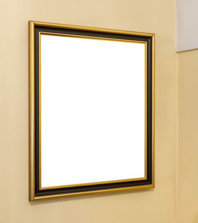 Gold edged rectangle picture frame hanging on a beige wall with empty blank white inside part simple...