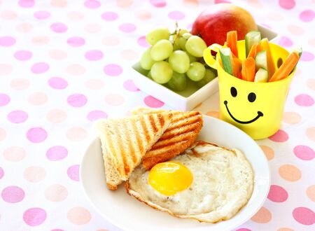 breakfast including egg, toast, fruits の写真素材