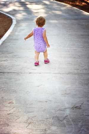  Toddler learning to walk by herself の写真素材