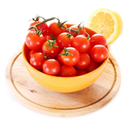 Tomatoes and lemon isolated on white background の写真素材