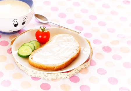 Healthy food for diet as bread and vegetables with measurement tape の写真素材