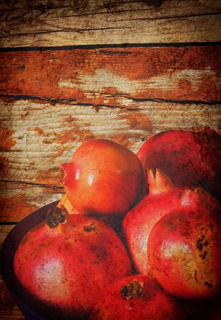 wooden garunge background with pomegranateの写真素材
