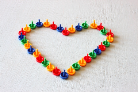 heart shape made of colorful pinsの写真素材