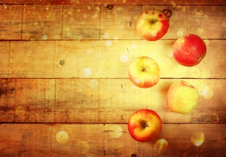 apples on wooden background with glitter lights の写真素材