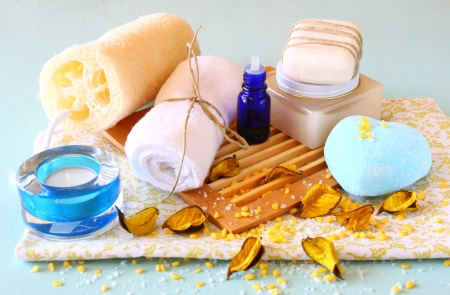 Spa and wellness setting with natural soap, candles and towel  aqua wooden backgroundの写真素材