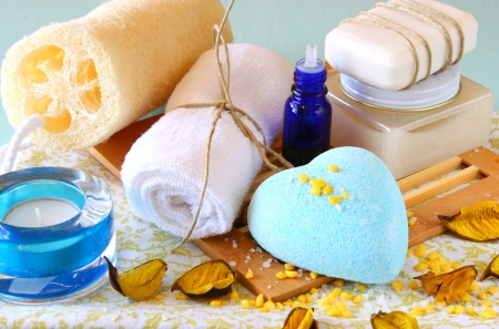 Spa and wellness setting with natural soap, candles and towel  aqua wooden backgroundの写真素材