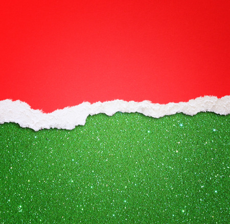 red torn paper over green glitter backgroundの写真素材
