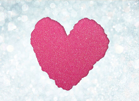 red heart shape made from torn paper over glitter boke soft lights の写真素材