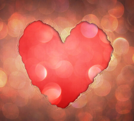 heart shape made from torn paper over glitter boke soft lights の写真素材