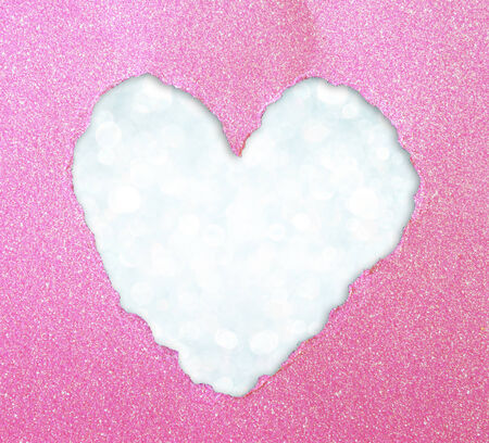 heart shape made from torn paper over glitter boke soft lights の写真素材