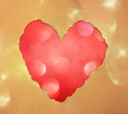 red heart shape made from torn paper over glitter boke soft lights の写真素材
