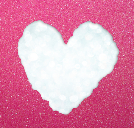 heart shape made from torn paper over glitter boke soft lights の写真素材
