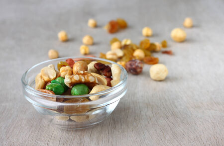 Assorted healthy mixed nuts on wooden textured background  の写真素材