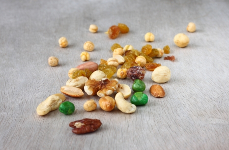 Assorted healthy mixed nuts on wooden textured background  の写真素材