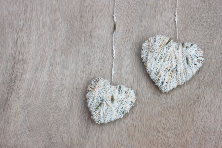 hearts hanging over wooden textured  の写真素材