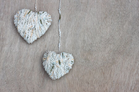 hearts hanging over wooden textured の写真素材