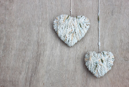 hearts hanging over wooden textured の写真素材