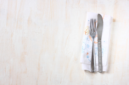 top view of silver fork and knife over wooden textured background  room for text   の写真素材