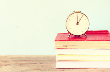 vintage clock on books  vintage effectの写真素材