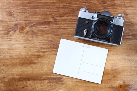 vintage old camera and postcard on wooden background  room for text   の写真素材