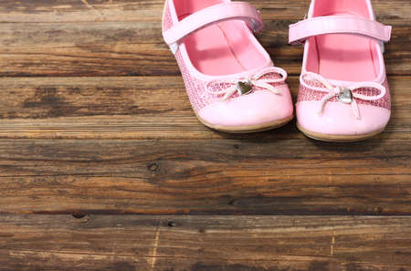 girl shoes over wooden deck floor の写真素材