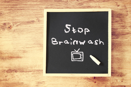 stop brainwash concept over blackboard  の写真素材