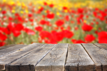 Empty wooden table with field of flowers background  can be used for product display  の写真素材