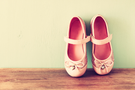 girl shoes over wooden deck floor  filtered image   の写真素材