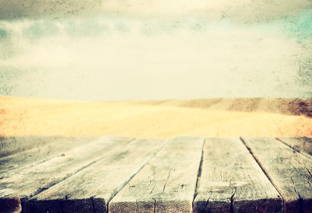 wood planks in front of sea landscape  lens flare  filtered image  の写真素材