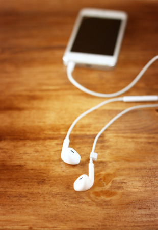 white earphones attached to smartphone  selective focus on earphones,  の写真素材